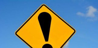 Yellow caution sign with exclamation mark symbol.