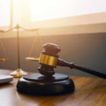 Gavel and scales of justice on desk.