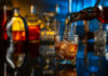 Pouring whiskey into a glass with ice