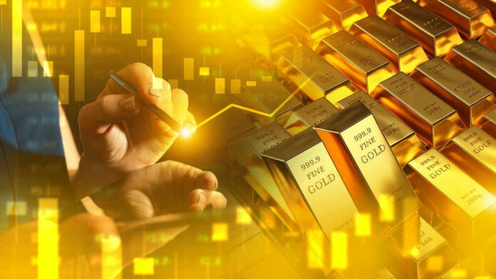 shutterstock_2498221953.jpg Hand writing near stacked gold bars and charts