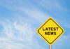 Yellow sign with text Latest News on sky background