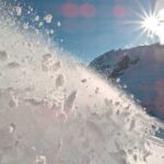 Unprecedented Freeze — Travel Nightmare Begins Snow spraying from a slope under a bright sun