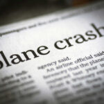 Plane CRASHES — Eight Aboard Newspaper headline about a plane crash.