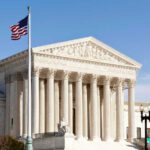 U.S. Supreme Court building with American flag.