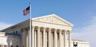 U.S. Supreme Court building with American flag.