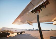 Fueling an aircraft at the airport with a hose connected to the wing