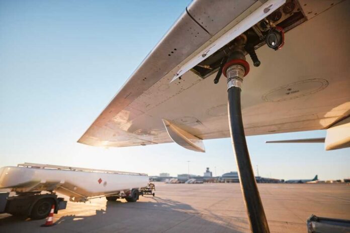 Fueling an aircraft at the airport with a hose connected to the wing