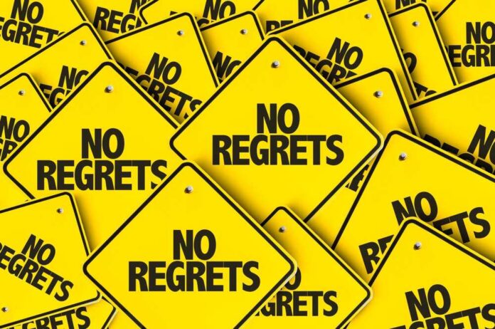 A collection of yellow signs displaying the phrase 'No Regrets'