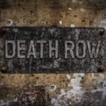 Weathered metal sign reading 'DEATH ROW' on a wall