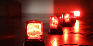 Red emergency lights on dark floor, illuminating the area.