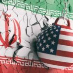 A wrecking ball painted with the American flag is breaking through a wall featuring the Iranian flag