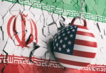 American-Born Pope Drops Iran War Bombshell A wrecking ball painted with the American flag is breaking through a wall featuring the Iranian flag