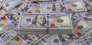 Stack of one hundred dollar bills, Benjamin Franklins portrait.