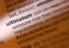 Close-up of a dictionary page showing the definition of 'ultimatum'