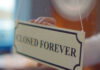 Closed forever sign being placed on window.