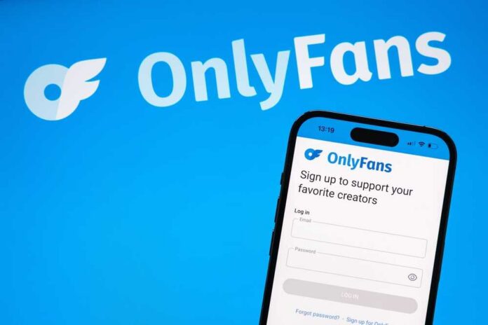 Mobile phone displaying the OnlyFans login screen on a blue background