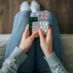 Medication Quietly DESTROYING America’s Food Industry? Person holding multiple blister packs of pills