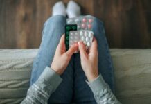 Medication Quietly DESTROYING America’s Food Industry? Person holding multiple blister packs of pills