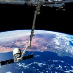 View of Earth from the International Space Station with a satellite in focus