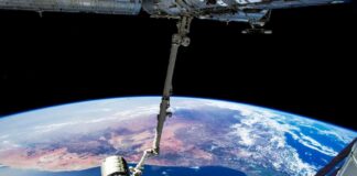 View of Earth from the International Space Station with a satellite in focus