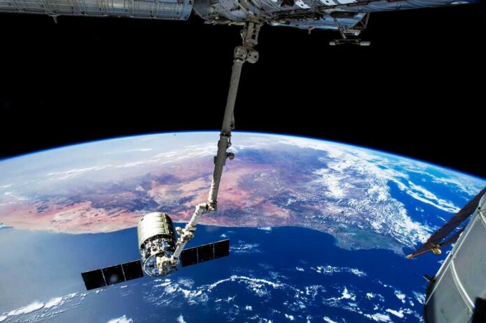 View of Earth from the International Space Station with a satellite in focus