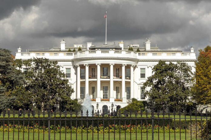 The White House with dark clouds overhead.