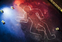 Crime scene chalk outline with numbered evidence markers.