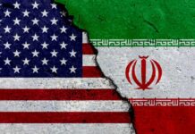 A cracked surface displaying the flags of the USA and Iran