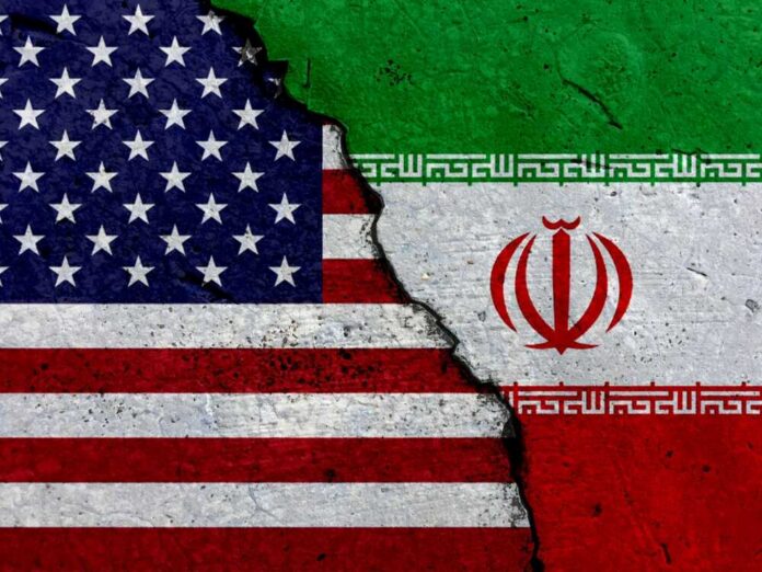 A cracked surface displaying the flags of the USA and Iran