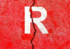 Cracked red wall with white letter R.