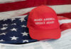 MAGA Civil War Erupts Over Iran Red Make America Great Again hat on American flag