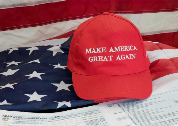 shutterstock_2240568885.jpg Red Make America Great Again hat on American flag