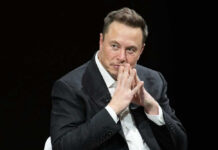Elon Musk in suit thinking.