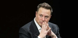 Elon Musk in suit thinking.