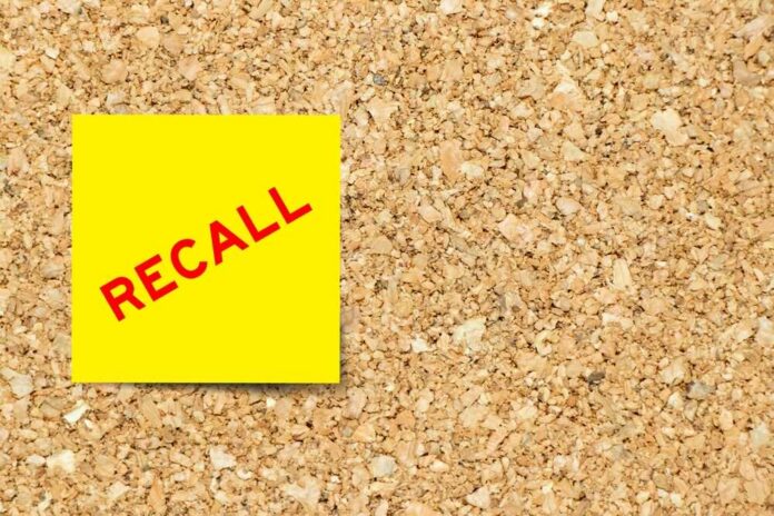 Yellow sticky note with the word 'RECALL' on a corkboard