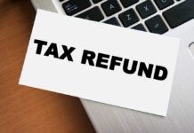 A card displaying the words 'TAX REFUND' placed on a laptop keyboard