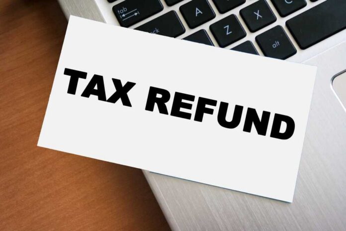 A card displaying the words 'TAX REFUND' placed on a laptop keyboard