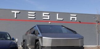 Tesla Cybertruck parked in front of a Tesla dealership