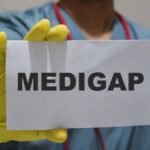 Medical professional holding a sign that says 'MEDIGAP'