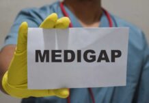 Medical professional holding a sign that says 'MEDIGAP'