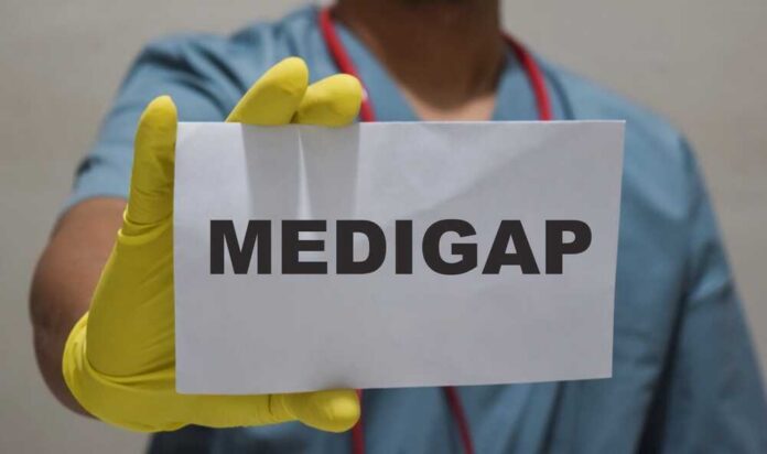 Medical professional holding a sign that says 'MEDIGAP'