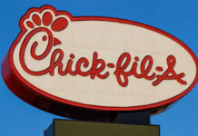 Chick-fil-A Storm: Sabbath Firing Sparks Legal Battle Chick-fil-A restaurant sign illuminated against a blue sky