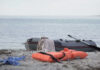 Missing Wife Sparks High-Seas Drama An inflatable boat on the beach with a life jacket and clothes nearby