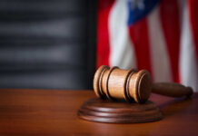 Actor’s Brutal Attack: Shocking Courtroom Drama A wooden gavel resting on a sound block with an American flag in the background