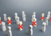 $145B AI Investment Makes Jobs Disappear! Wooden figures with red X marks, signifying eliminated individuals.