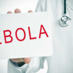 Doctor holding a sign about Ebola