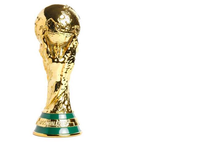 Golden trophy representing the World Cup held by hands