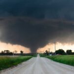 Tornado Emergency — Communities Decimated A tornado forming in a rural area with dark storm clouds overhead