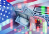 Water Bills SURGE — Millions Can’t Afford USA flag calculator and hands holding dollars overlapping