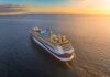 A cruise ship sailing on calm waters during sunset